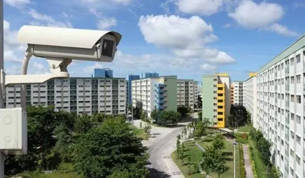 CCTV camera mounted on a wall overlooking a residential complex and its internal roads