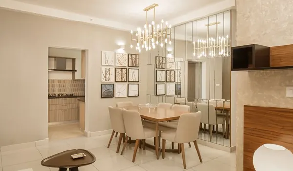 Dining area with a six-seater table, pendant lighting and adjoining living space