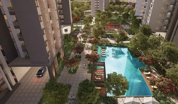 Outdoor swimming pool with a paved deck, loungers and landscaped surroundings