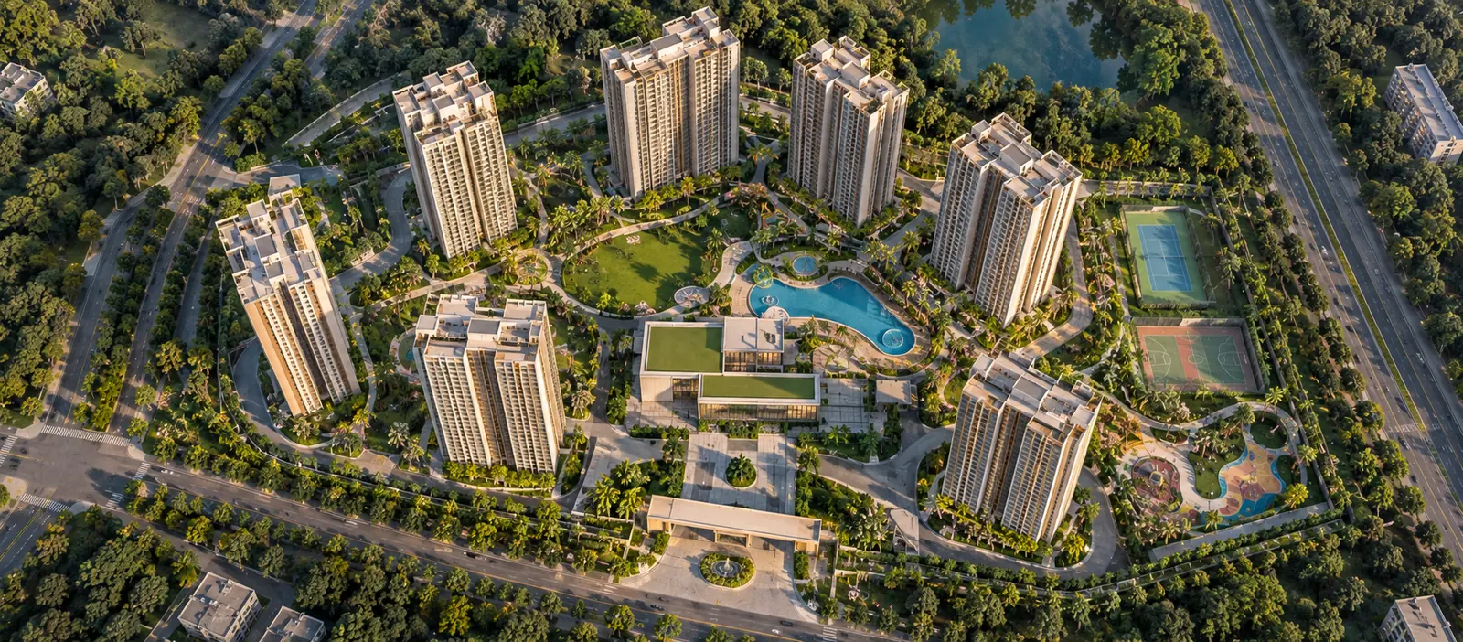 Top-down aerial view of a residential township showing towers, internal roads, gardens and amenity zones