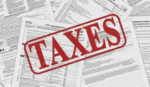 Tax documents and forms stamped with the word taxes